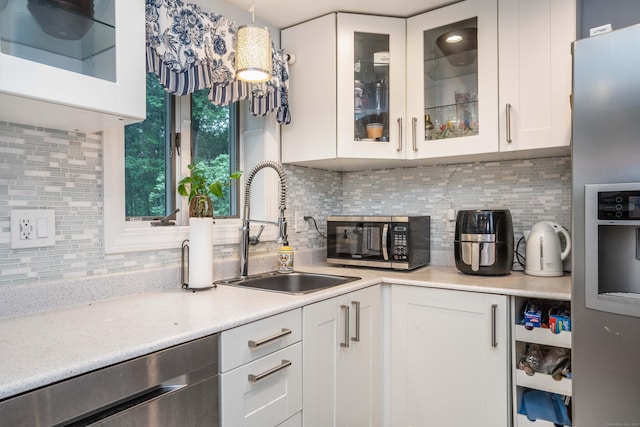 244 Stanwood Dr, New Britain, CT 06053 - kitchen with stainless steel appliances, light countertops, tasteful backsplash, white cabinets, and glass insert cabinets