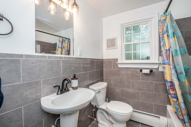 244 Stanwood Dr, New Britain, CT 06053 - bathroom featuring tile walls, baseboard heating, wainscoting, and shower / tub combo with curtain