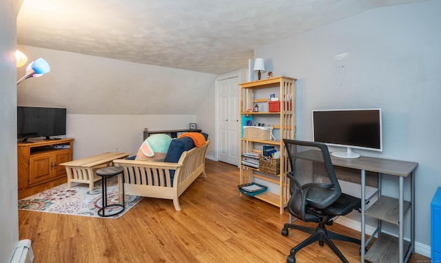 244 Stanwood Dr, New Britain, CT 06053 - bedroom with light wood-type flooring, a desk, lofted ceiling, a baseboard heating unit, and a textured ceiling