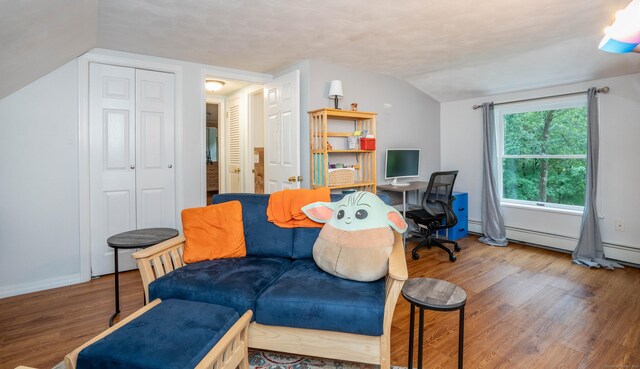 244 Stanwood Dr, New Britain, CT 06053 - living area with lofted ceiling, wood finished floors, and a baseboard heating unit