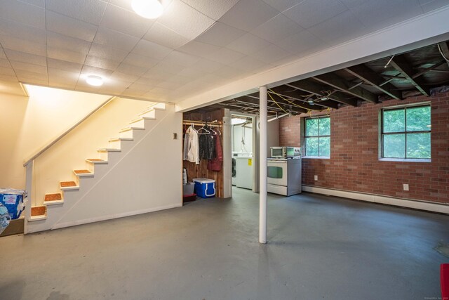 244 Stanwood Dr, New Britain, CT 06053 - basement with a baseboard heating unit, stairway, and brick wall