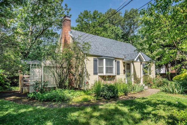244 Stanwood Dr, New Britain, CT 06053 - view of front of home featuring a shingled roof, a chimney, and a front yard
