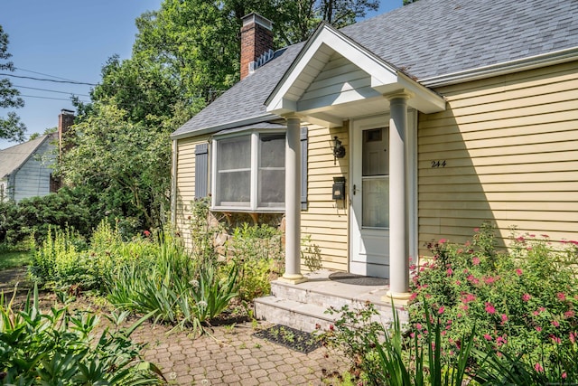 244 Stanwood Dr, New Britain, CT 06053 - property entrance with a chimney and a shingled roof