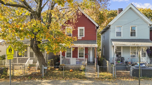 666 Orchard St, New Haven, CT 06511 - view of front facade with a porch, a gate, a chimney, a fenced front yard, and cooling unit