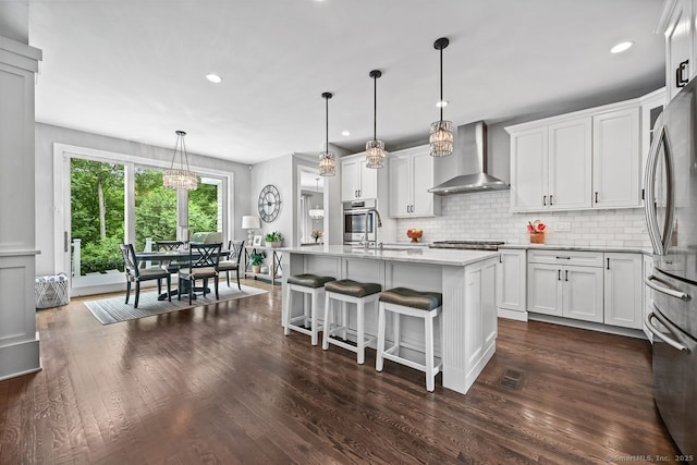 7 Forest View Dr, Newtown, CT 06482 - kitchen with wall chimney range hood, stainless steel appliances, tasteful backsplash, a chandelier, and recessed lighting