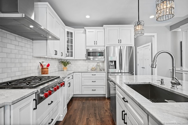 7 Forest View Dr, Newtown, CT 06482 - kitchen with wall chimney range hood, appliances with stainless steel finishes, white cabinets, a chandelier, and glass insert cabinets