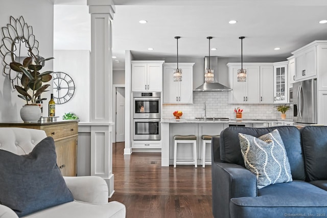 7 Forest View Dr, Newtown, CT 06482 - living area featuring dark wood-style floors, ornate columns, and recessed lighting