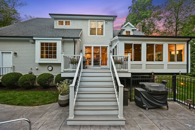 7 Forest View Dr, Newtown, CT 06482 - back of property at dusk with a shingled roof, stairway, a chimney, and a patio