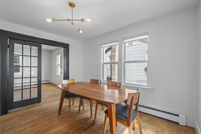 94 Prospect Ave, West Haven, CT 06516 - dining room with baseboard heating, light wood-style flooring, and a chandelier