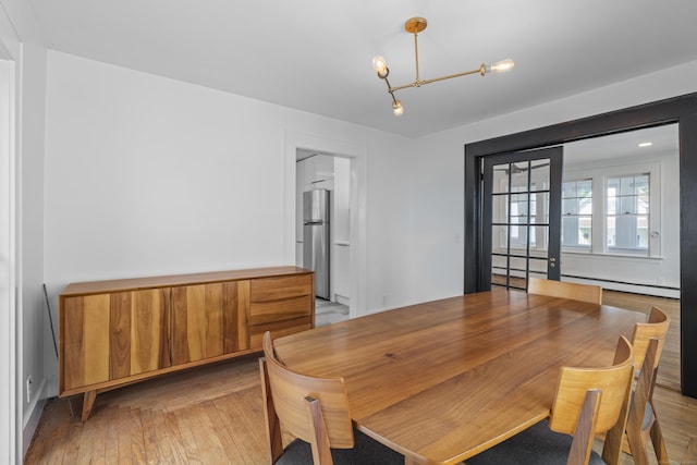 94 Prospect Ave, West Haven, CT 06516 - dining space featuring light wood-type flooring, a chandelier, and a baseboard radiator