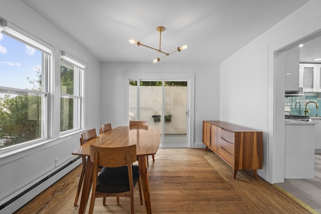 94 Prospect Ave, West Haven, CT 06516 - dining space featuring a baseboard radiator, a chandelier, and light wood-style flooring