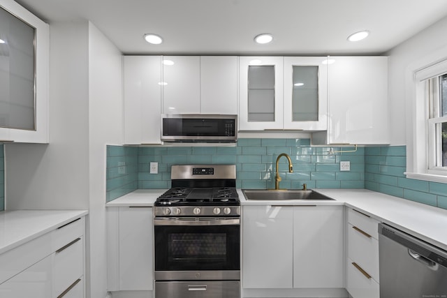94 Prospect Ave, West Haven, CT 06516 - kitchen with stainless steel appliances, white cabinets, modern cabinets, light countertops, and recessed lighting