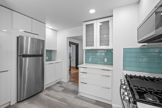 94 Prospect Ave, West Haven, CT 06516 - kitchen featuring stainless steel appliances, white cabinets, light countertops, glass insert cabinets, and recessed lighting