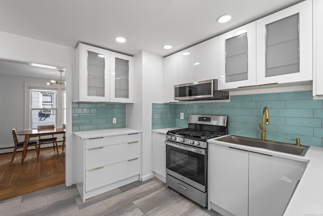 94 Prospect Ave, West Haven, CT 06516 - kitchen featuring stainless steel appliances, white cabinetry, light countertops, modern cabinets, and recessed lighting