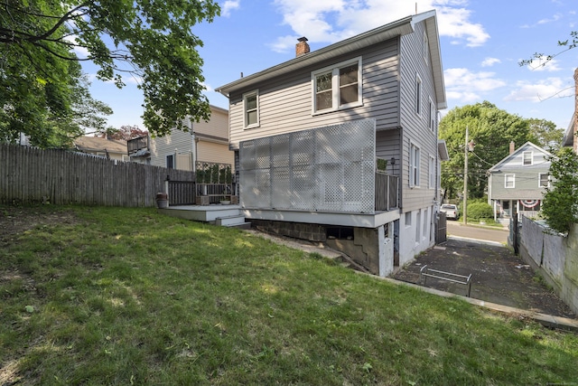 94 Prospect Ave, West Haven, CT 06516 - rear view of house with a chimney, a wooden deck, and a garage