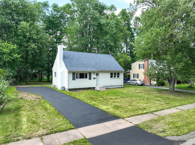 32 Miles Standish Dr, West Hartford, CT 06107 - view of front of property featuring a chimney, roof with shingles, asphalt driveway, and a front lawn