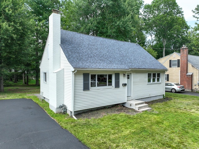 32 Miles Standish Dr, West Hartford, CT 06107 - view of front of house with a chimney, a shingled roof, and a front yard