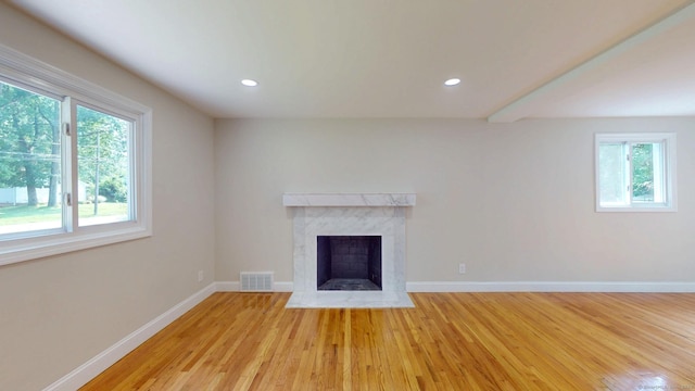 32 Miles Standish Dr, West Hartford, CT 06107 - unfurnished living room with light wood-style floors, a high end fireplace, and recessed lighting