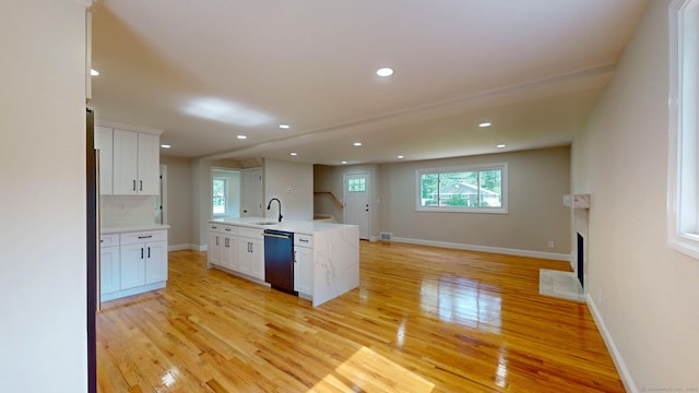 32 Miles Standish Dr, West Hartford, CT 06107 - kitchen featuring dishwashing machine, light wood-style flooring, open floor plan, white cabinetry, and recessed lighting