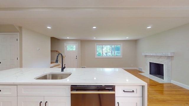32 Miles Standish Dr, West Hartford, CT 06107 - kitchen with dishwashing machine, open floor plan, light wood-style flooring, white cabinetry, and light stone countertops