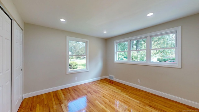 32 Miles Standish Dr, West Hartford, CT 06107 - unfurnished bedroom featuring multiple windows, light wood-style floors, recessed lighting, and a closet