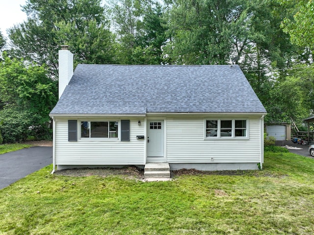 32 Miles Standish Dr, West Hartford, CT 06107 - view of front of home with a shingled roof, a front lawn, and a chimney