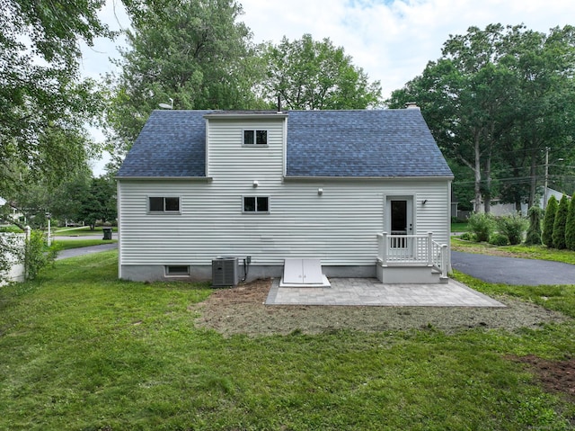 32 Miles Standish Dr, West Hartford, CT 06107 - back of property with roof with shingles, a yard, and a patio