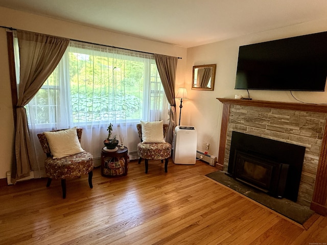 175 Luna Trail Ext, Southbury, CT 06488 - living area with wood finished floors, a fireplace, and a baseboard heating unit
