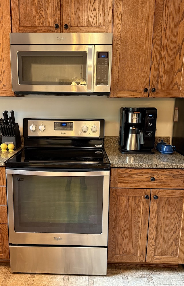 175 Luna Trail Ext, Southbury, CT 06488 - kitchen featuring stainless steel appliances, brown cabinets, and dark stone counters