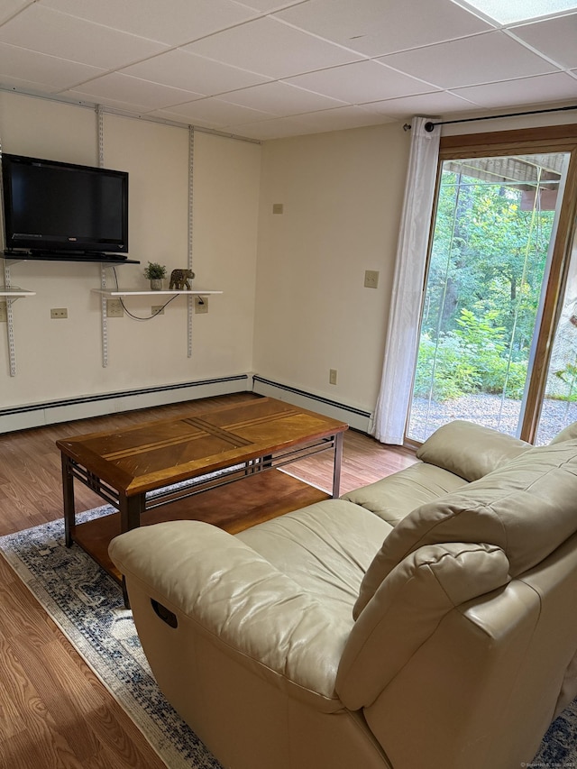 175 Luna Trail Ext, Southbury, CT 06488 - living room featuring a paneled ceiling, wood finished floors, and a baseboard heating unit
