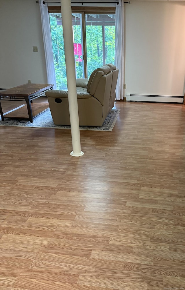175 Luna Trail Ext, Southbury, CT 06488 - living area featuring light wood finished floors and a baseboard heating unit