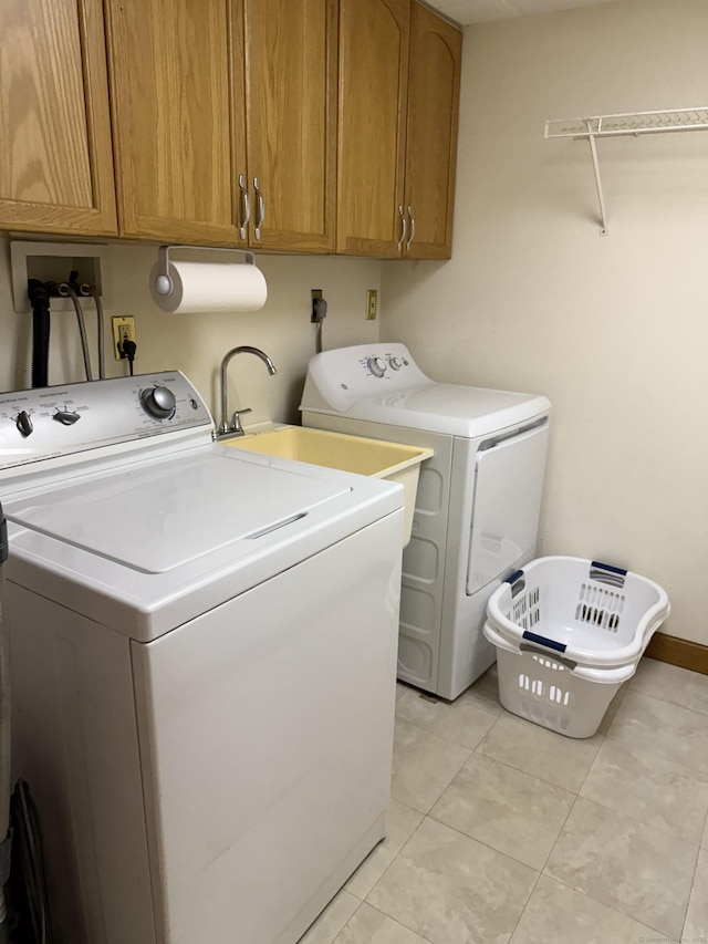 175 Luna Trail Ext, Southbury, CT 06488 - laundry area with washer and clothes dryer, cabinet space, and light tile patterned flooring