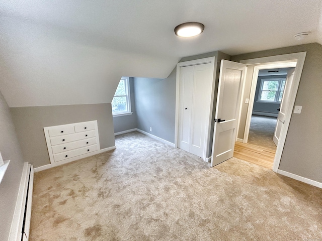 342 Middle Tpke E, Manchester, CT 06040 - additional living space with a baseboard heating unit, carpet, baseboard heating, and vaulted ceiling