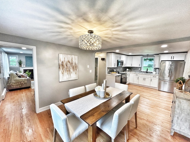 342 Middle Tpke E, Manchester, CT 06040 - dining space with light wood-style flooring, recessed lighting, and a chandelier