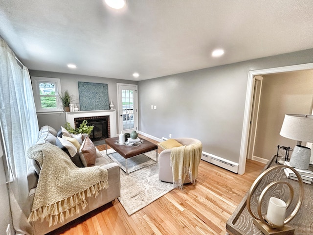 342 Middle Tpke E, Manchester, CT 06040 - living area with a baseboard radiator, light wood-style flooring, recessed lighting, and a fireplace
