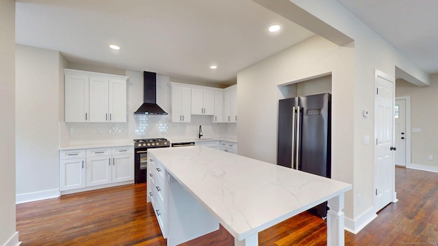 274 High St, Fairfield, CT 06824 - kitchen featuring wall chimney exhaust hood, range with gas stovetop, dark wood-type flooring, a center island, and white cabinets