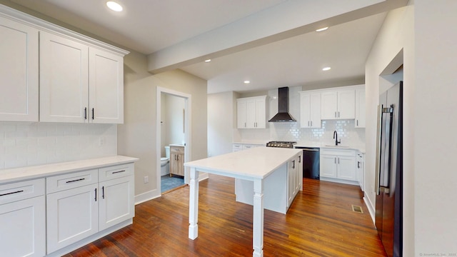 274 High St, Fairfield, CT 06824 - kitchen with wall chimney exhaust hood, tasteful backsplash, dark wood-style floors, a kitchen bar, and white cabinetry