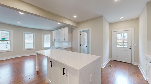 274 High St, Fairfield, CT 06824 - kitchen featuring dark wood-style flooring, white cabinetry, tasteful backsplash, light stone counters, and recessed lighting