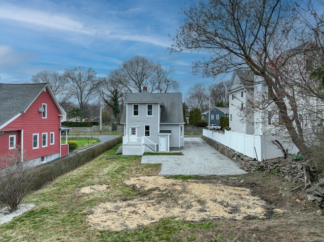 274 High St, Fairfield, CT 06824 - rear view of house featuring a chimney, roof with shingles, and driveway