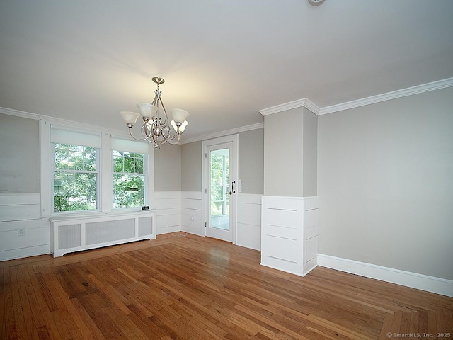 42 Homewood Ave, North Haven, CT 06473 - unfurnished room featuring radiator, a chandelier, crown molding, a wainscoted wall, and wood finished floors