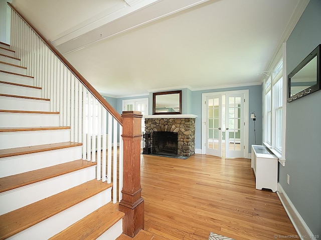 42 Homewood Ave, North Haven, CT 06473 - stairway featuring crown molding, french doors, wood finished floors, and a stone fireplace