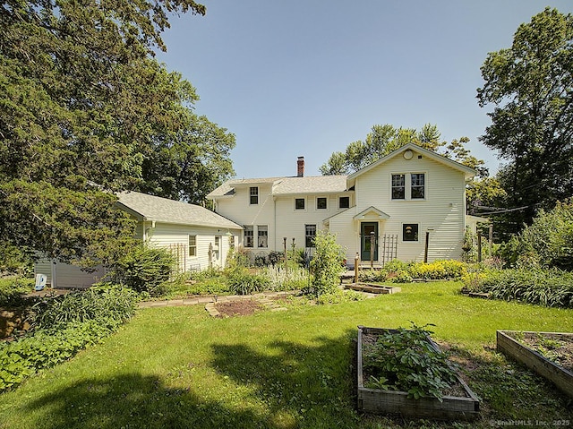 42 Homewood Ave, North Haven, CT 06473 - rear view of house with a garden, a chimney, and a yard
