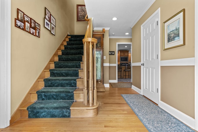 1199 Cornerstone Ct, Cheshire, CT 06410 - staircase with ornamental molding, wood finished floors, and recessed lighting