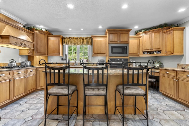 1199 Cornerstone Ct, Cheshire, CT 06410 - kitchen featuring black microwave, a kitchen breakfast bar, stone countertops, custom exhaust hood, and recessed lighting