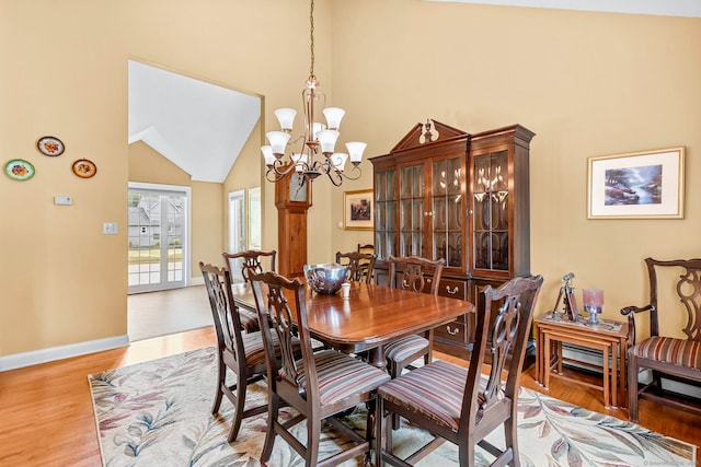 1199 Cornerstone Ct, Cheshire, CT 06410 - dining space with light wood finished floors, a chandelier, and high vaulted ceiling