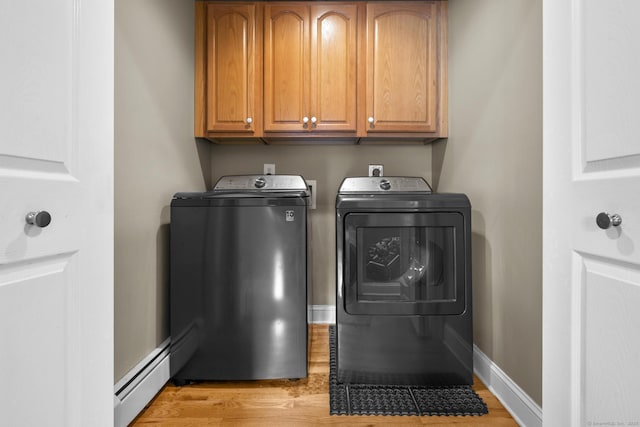1199 Cornerstone Ct, Cheshire, CT 06410 - laundry room with washer and dryer, baseboard heating, cabinet space, and light wood-style floors