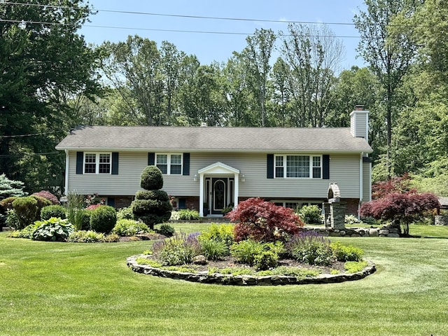 44 Fawn Hill Rd, Shelton, CT 06484 - bi-level home with a chimney, a front lawn, and brick siding