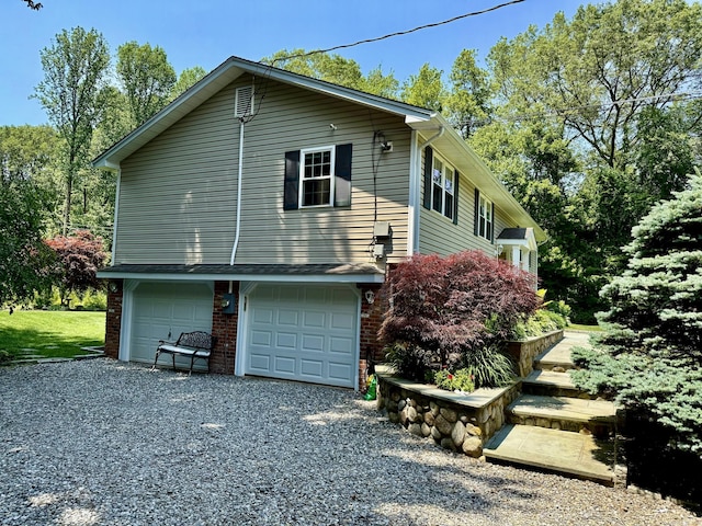 44 Fawn Hill Rd, Shelton, CT 06484 - view of property exterior with gravel driveway, a garage, and brick siding
