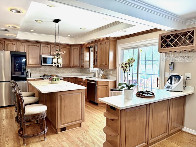 44 Fawn Hill Rd, Shelton, CT 06484 - kitchen featuring stainless steel appliances, a peninsula, light wood-type flooring, open shelves, and a breakfast bar area