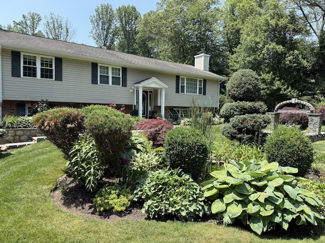 44 Fawn Hill Rd, Shelton, CT 06484 - bi-level home featuring a chimney, a front yard, and brick siding